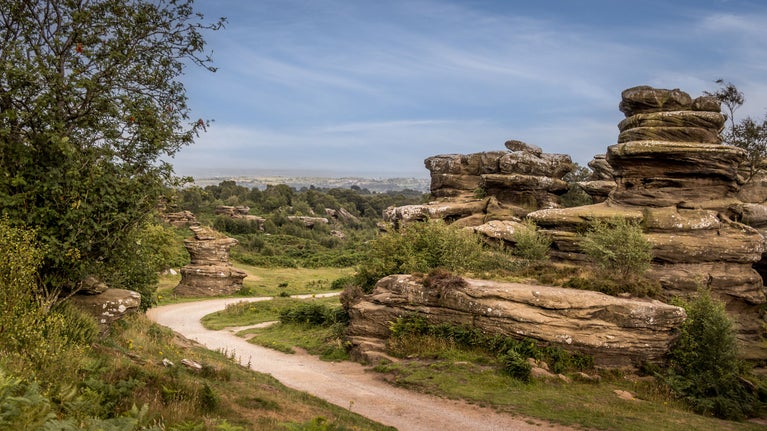 A path at Brimham Rocks passing one of the formations, North Yorkshire